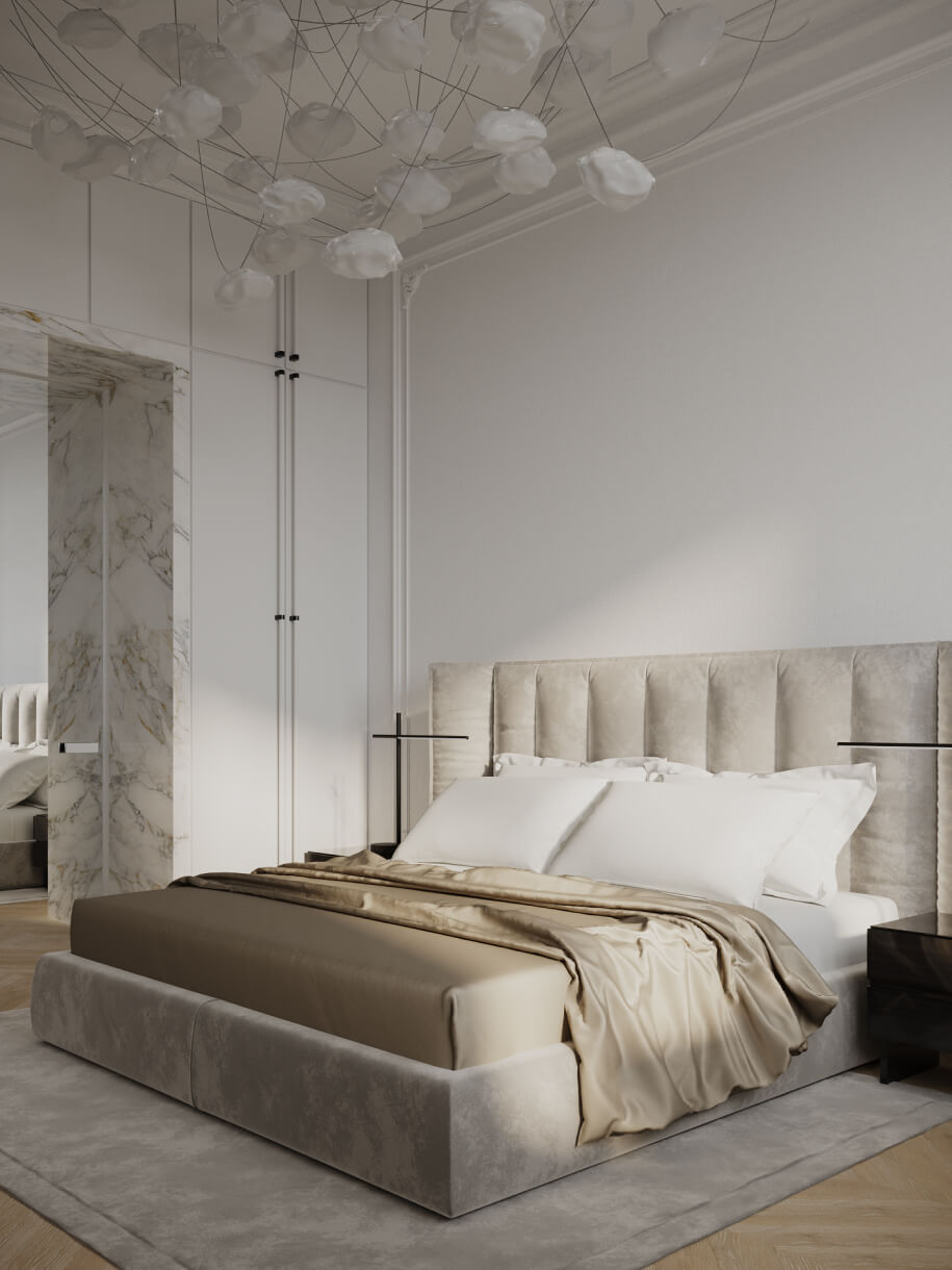 The bedroom showcases a serene sanctuary design for relaxation with the luxurious bed and the bespoke cloud-like chandelier.